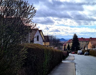 Litvínov-Osada, typická ulice s pohledem na mostecký Hněvín