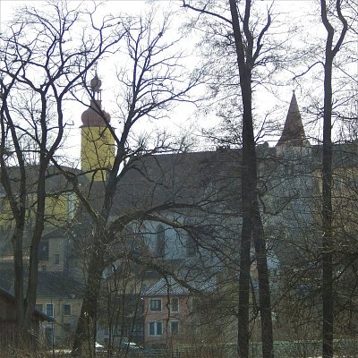 Věže kostela a zámku v mlženém oparu
