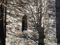 Stín stromu na zdi kamenného kostela v Horním Údolí